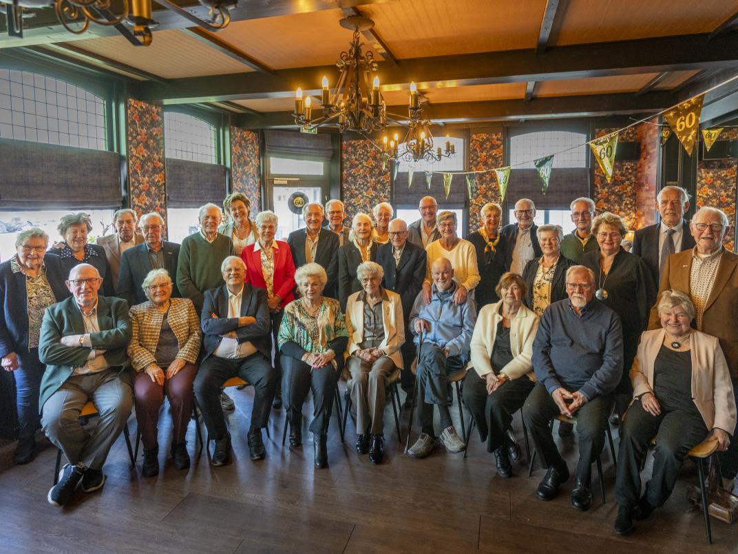 Groepsfoto van alle bruidsparen tijdens de huwelijksbijeenkomst